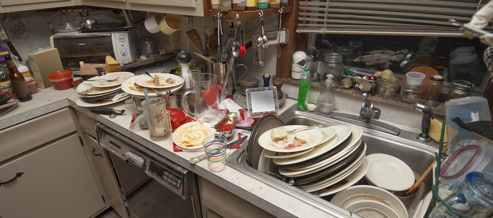 A sink full of filthy dishes.