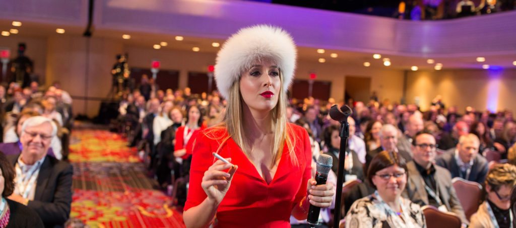 Realtor Cristina Cote in a red dress and furry hat as her alter ego