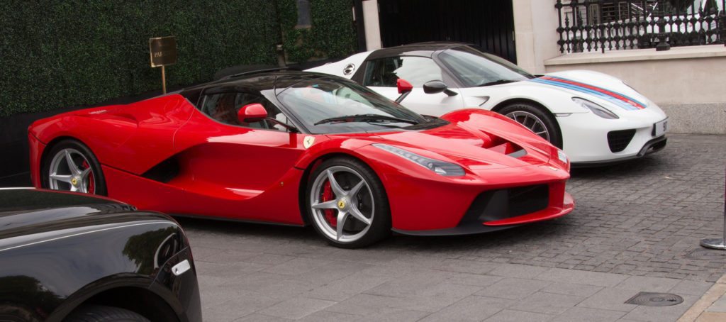 Two Italian sports cars, one red and one white, parked