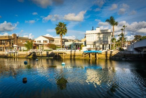 Boats and houses along Beacon Bay, in Newport Beach, California. Credit: Jon Bilous / Shutterstock.com