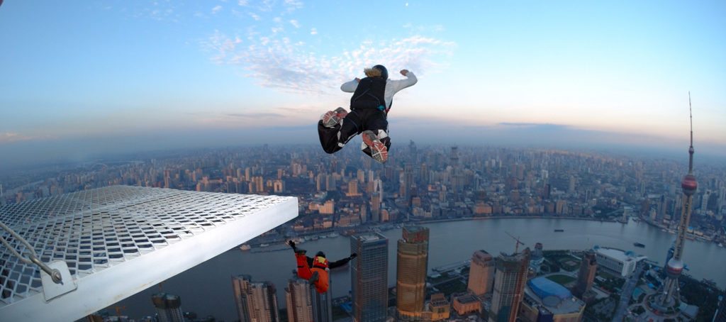 BASE jumpers jumping off a ledge