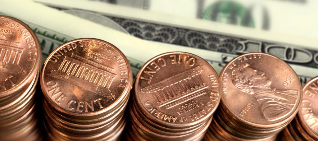 Stacks of pennies near dollar bills