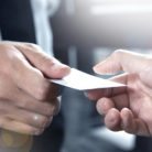 Two men exchanging business cards