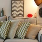 A living room with neutrals, graphic patterns and soft light