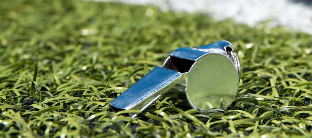 A coach's whistle on grass