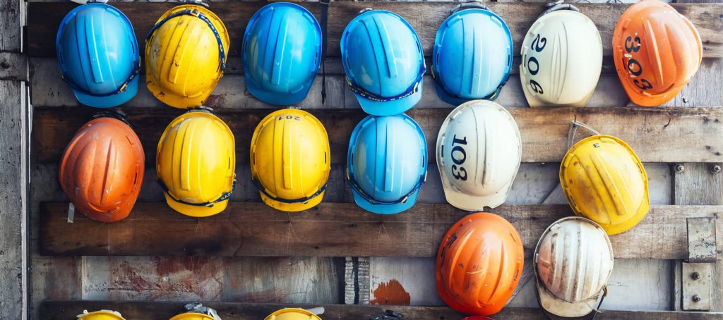 Rows of hard hats in a rack