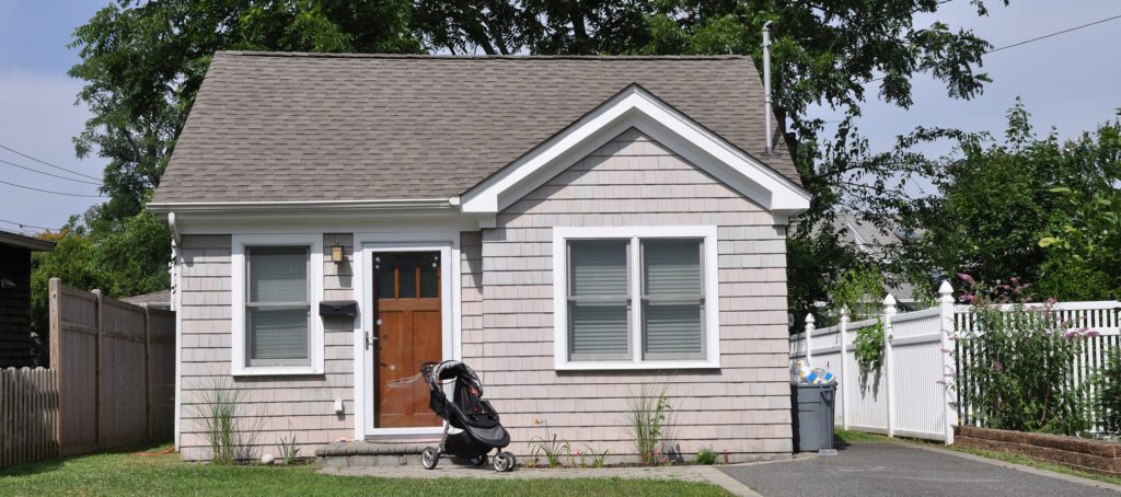 A small home with a baby stroller in front
