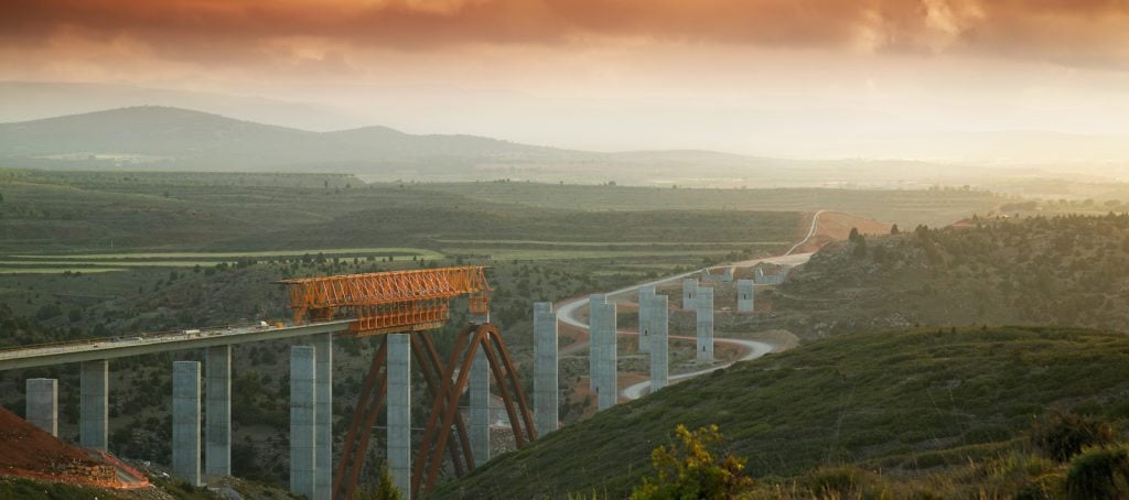 A bridge being built across a landscape