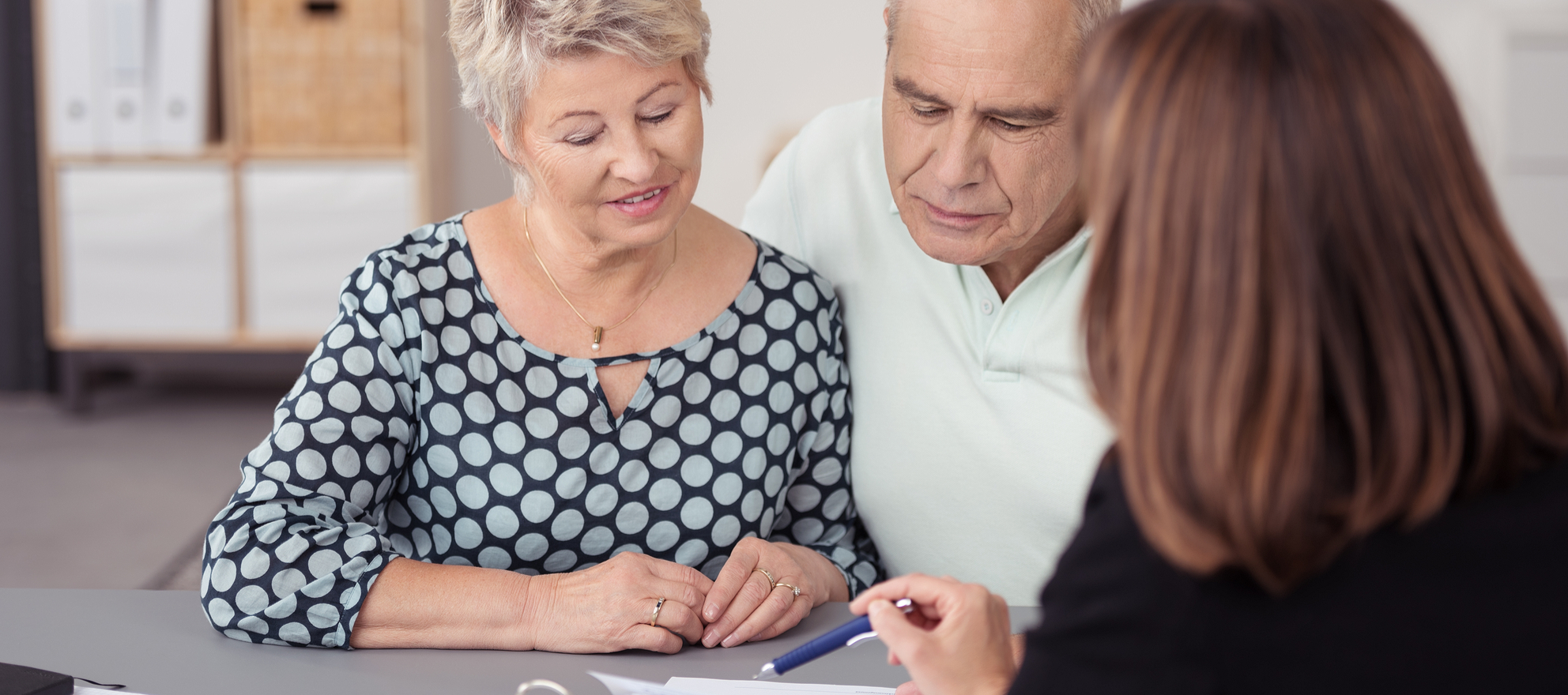 An older couple talking to a broker