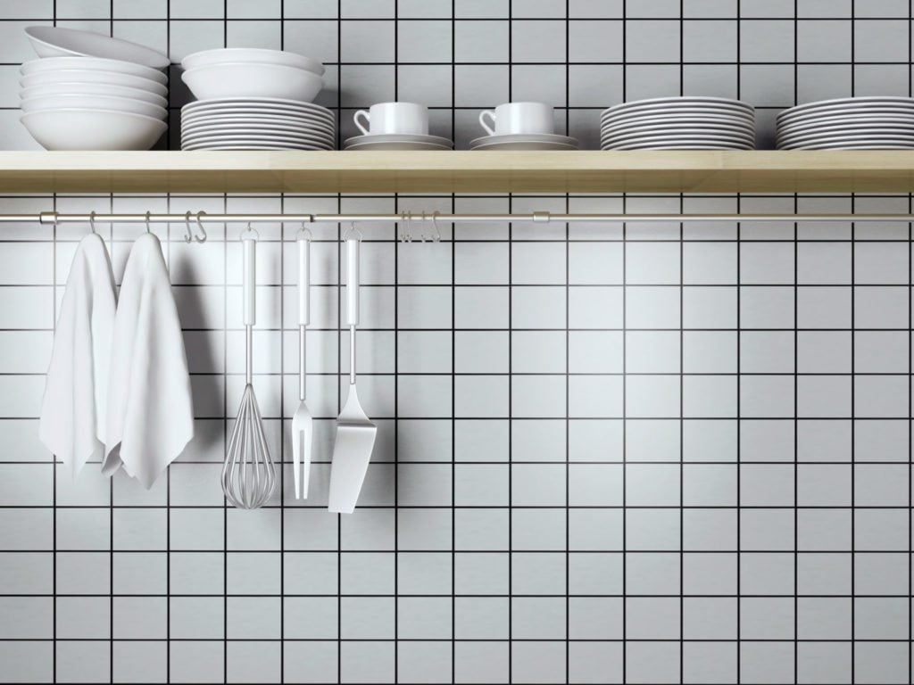 A wall of white tile in a kitchen