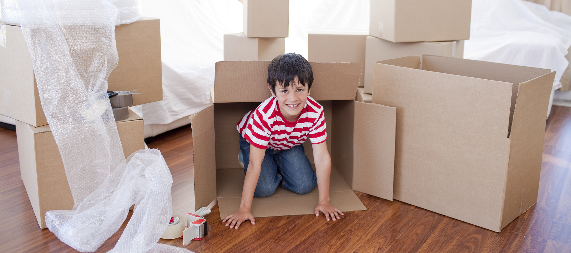 A child playing in moving boxes