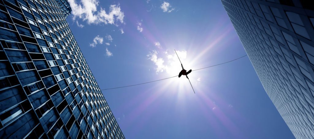 A tightrope walker between two buildings