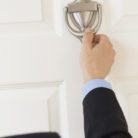 A man knocking on a door