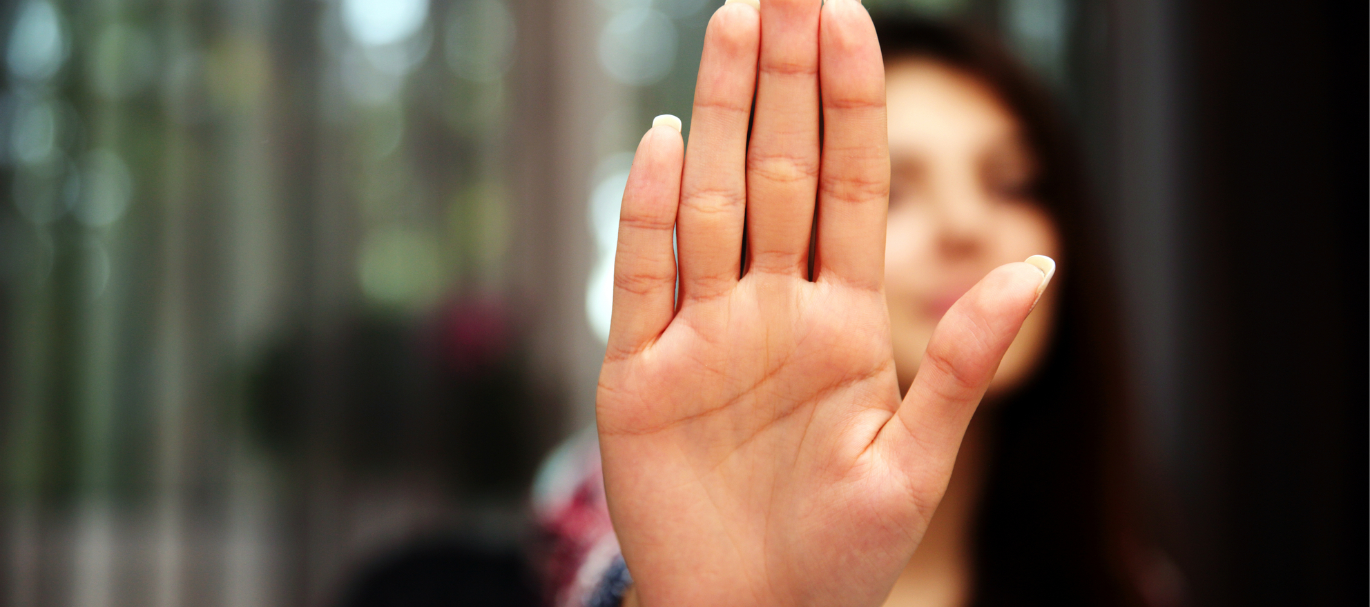 A woman holding up a hand in objection