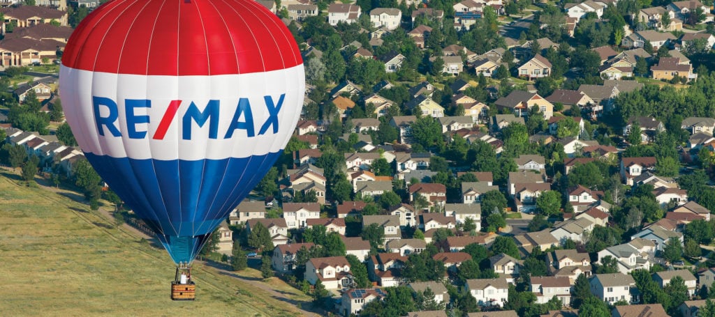 RE/MAX balloon floating over homes