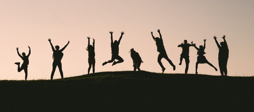 Silhouettes of people jumping