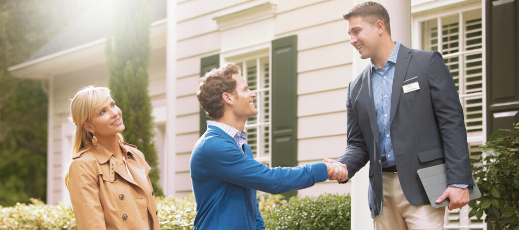 Men shaking hands on a front porch