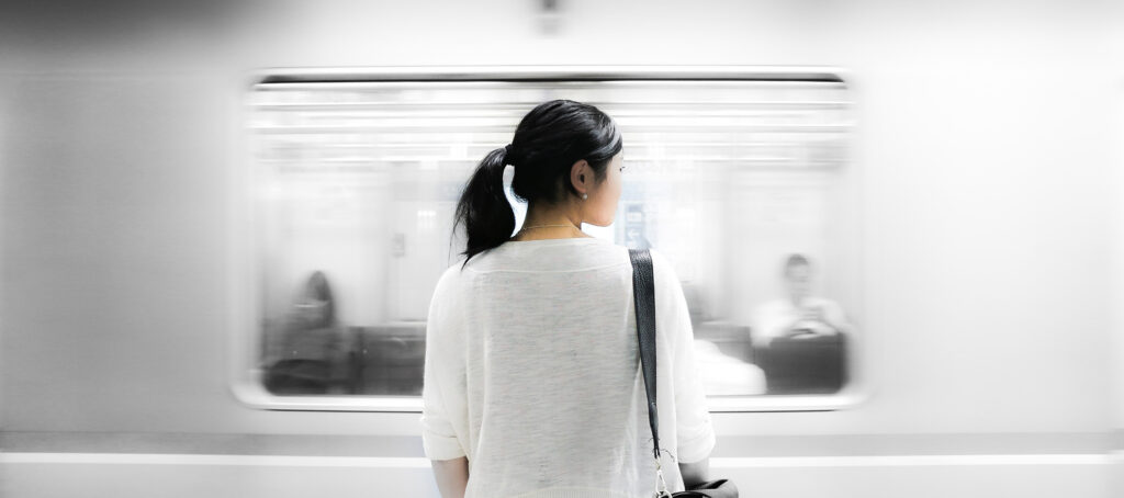 Woman watching a subway go by