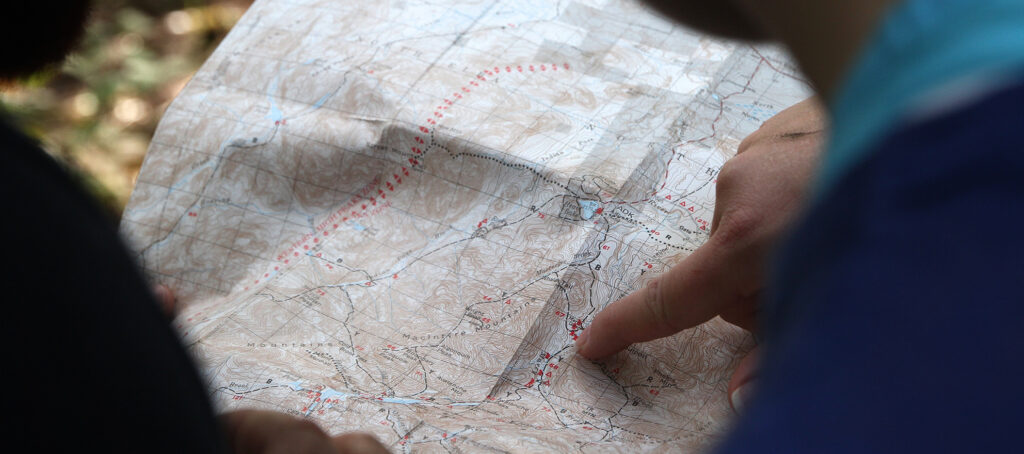 Person pointing to a destination on a roadmap