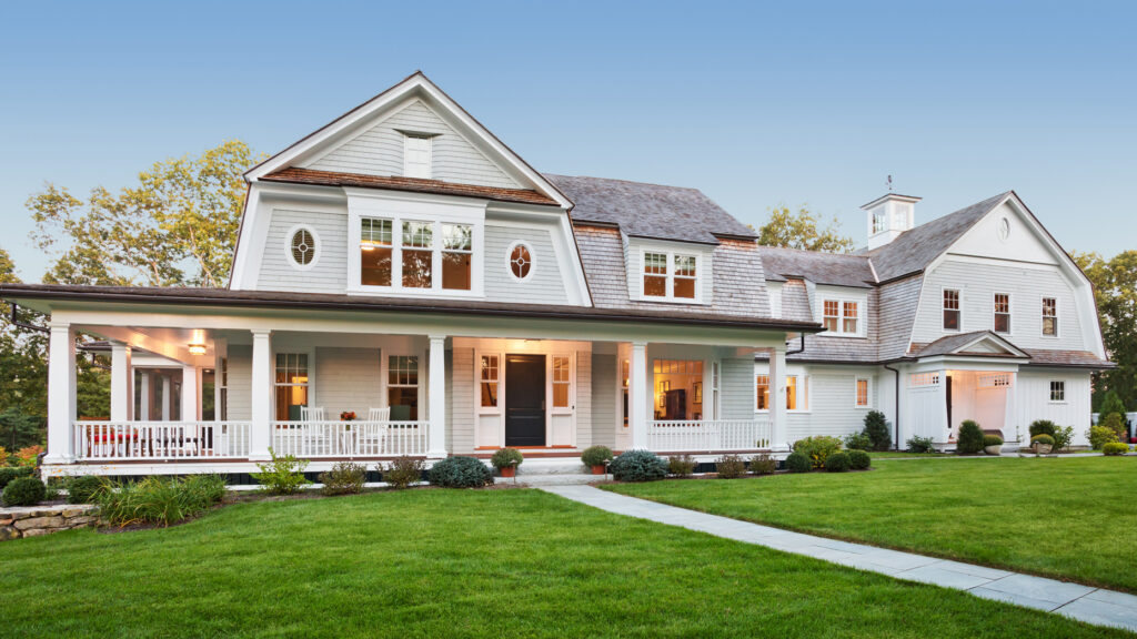 Exterior view of Custom styled home with manicured lawn and landscaping.
