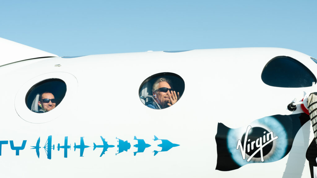 Richard Branson waves from the window of the VSS Unity22 on July 11, 2021 before its spaceflight.